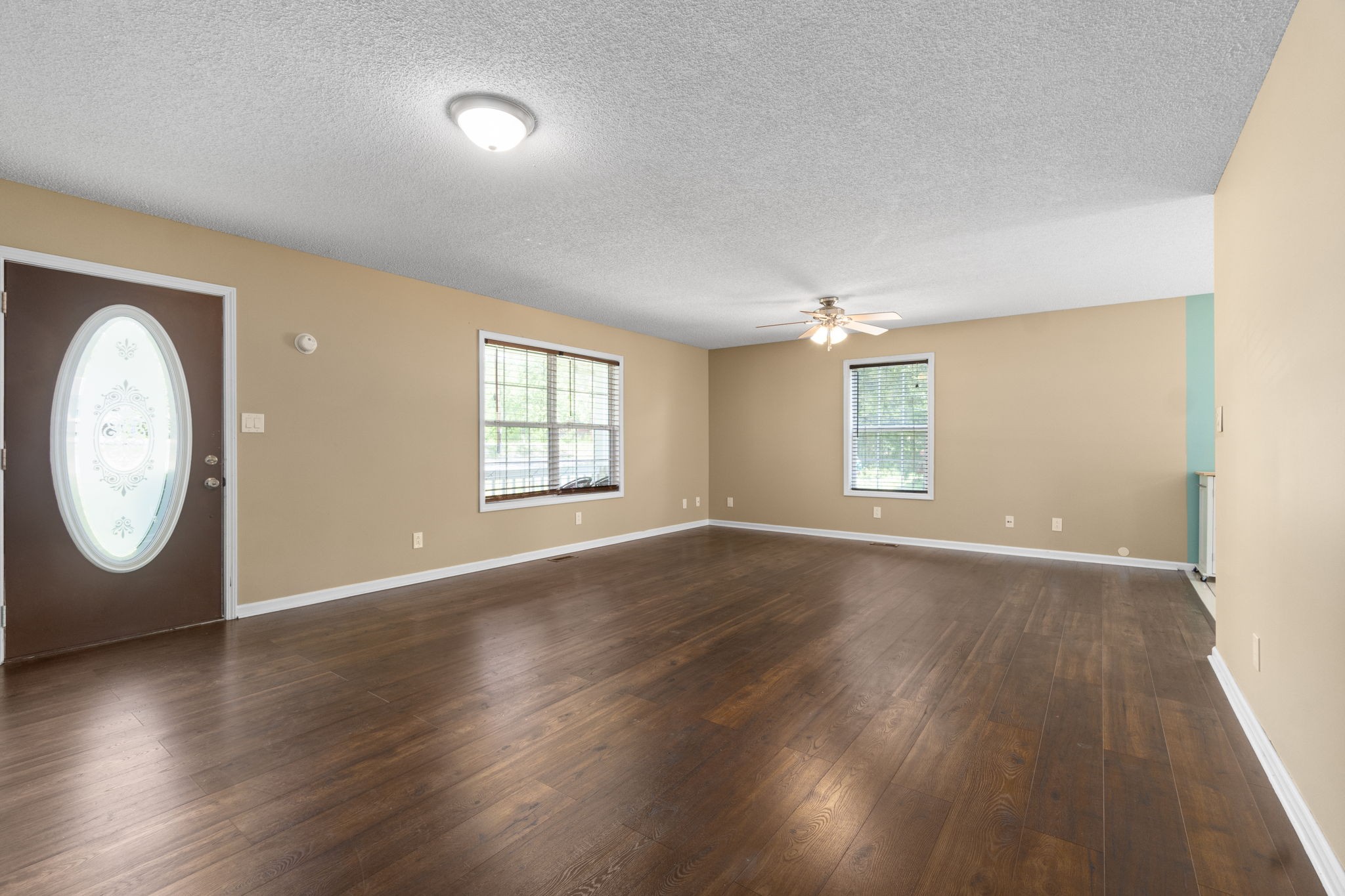3315 Lylewood Road Woodlawn, TN 37191 - Photo 6 of 39 an empty room with wooden floor and windows