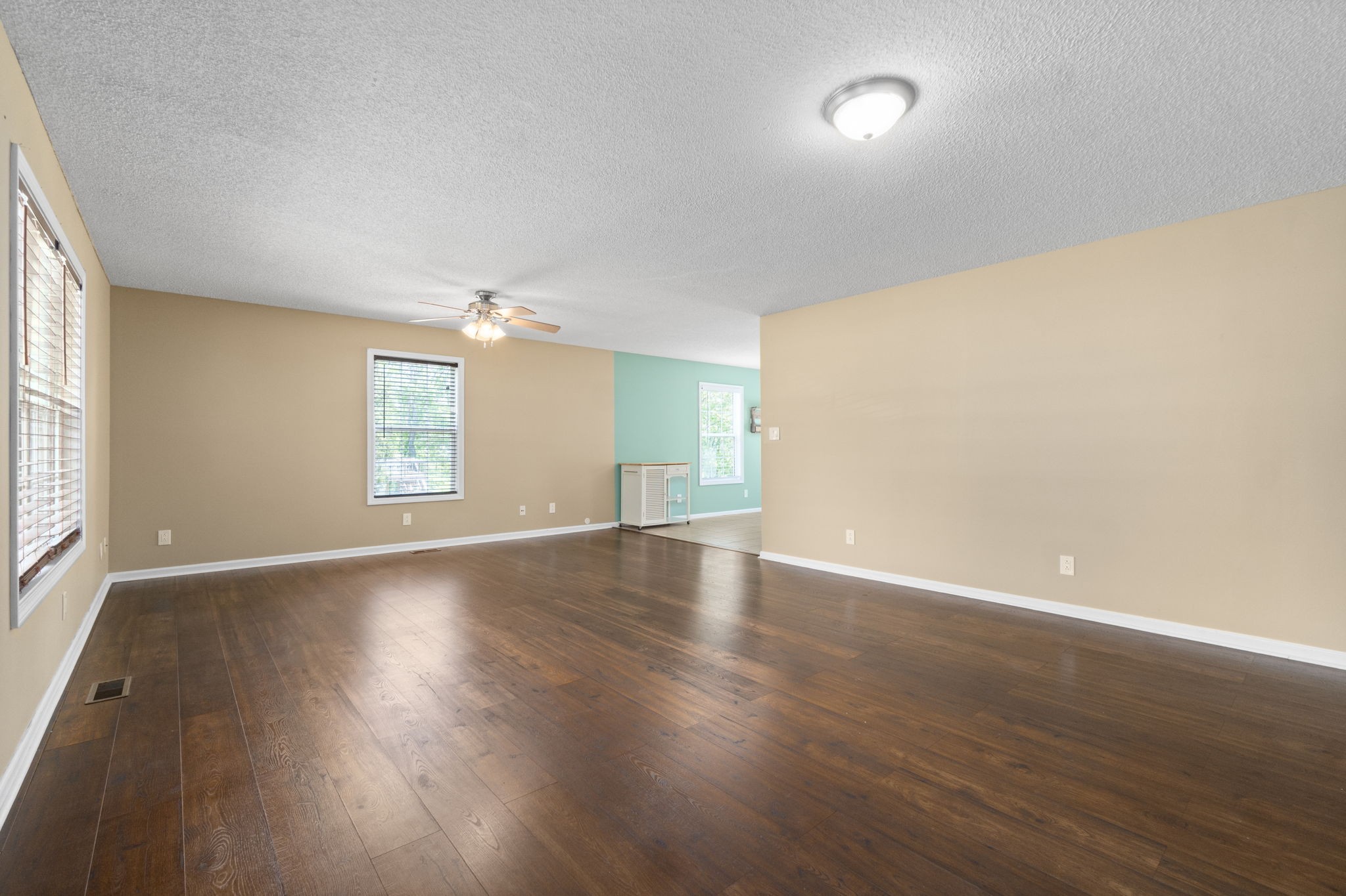 3315 Lylewood Road Woodlawn, TN 37191 - Photo 8 of 39 an empty room with wooden floor and windows