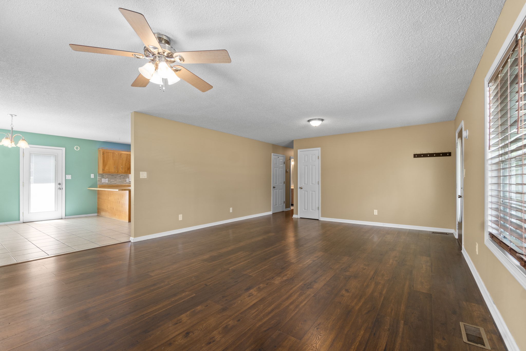 3315 Lylewood Road Woodlawn, TN 37191 - Photo 9 of 39 a view of an empty room with wooden floor and a window