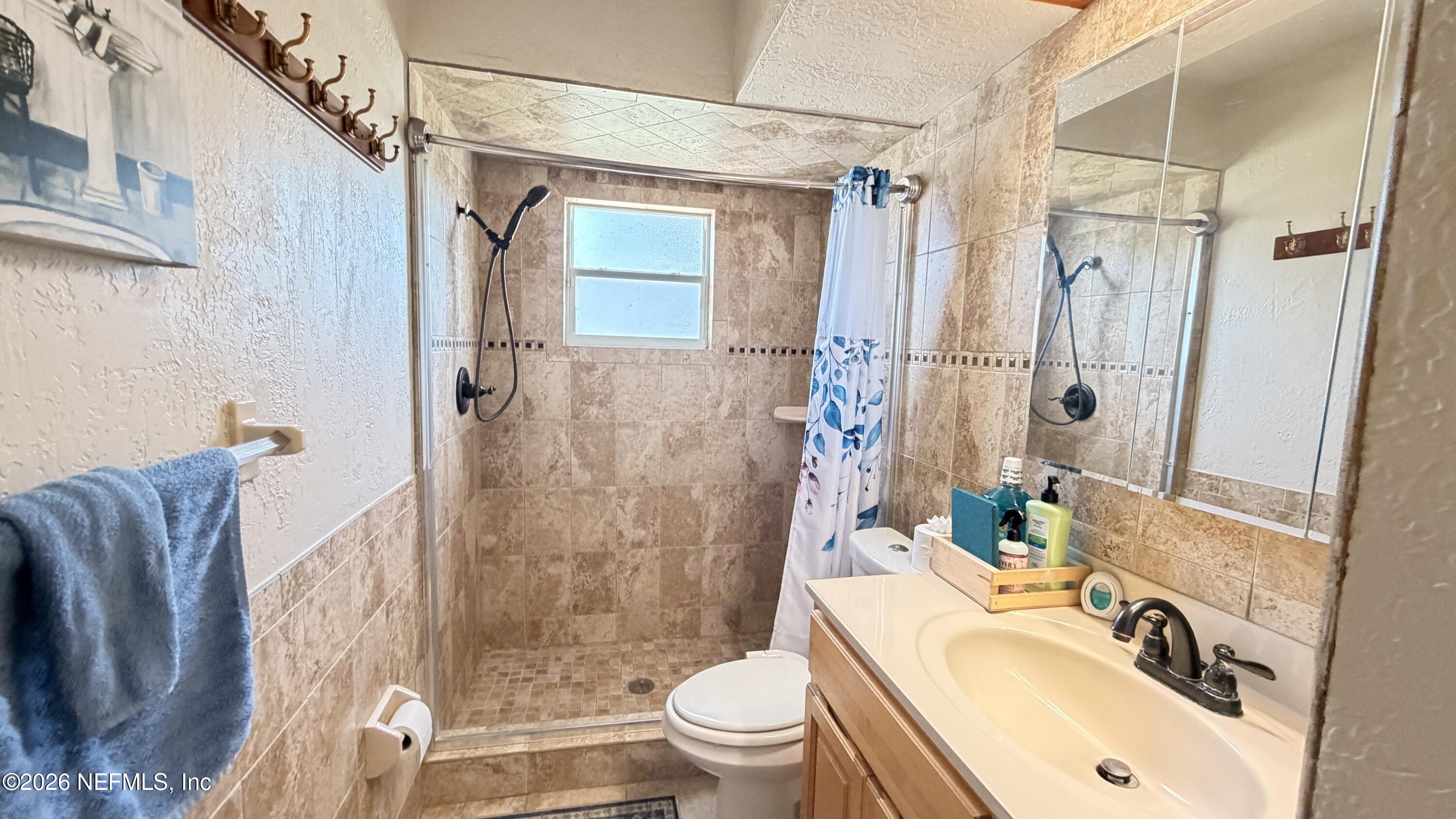 1302 Fort Meade Road Frostproof, FL 33843 - Photo 28 of 39 a bathroom with a sink toilet and shower