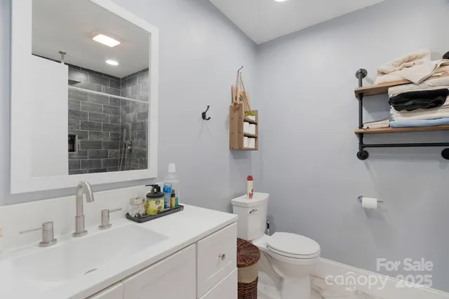 a bathroom with a sink toilet and a mirror