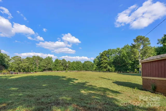 an aerial view of a residential houses with outdoor space