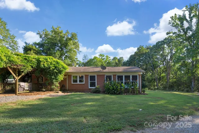 a front view of house with yard and green space