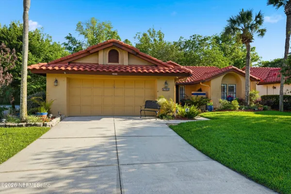 a front view of a house with a garden