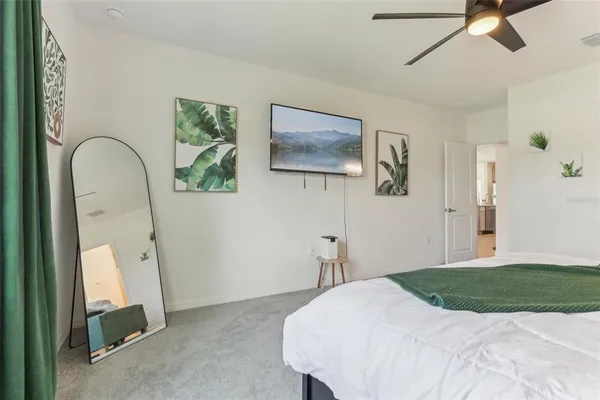 a bedroom with a bed and a chandelier