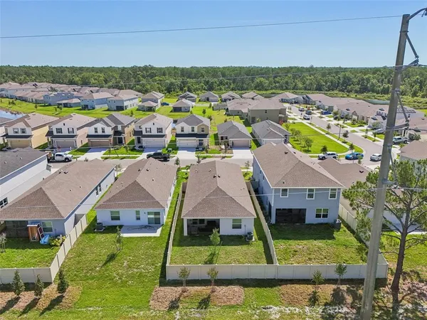 an aerial view of residential houses with outdoor space and swimming pool