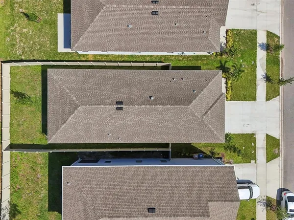 an aerial view of a house with a yard
