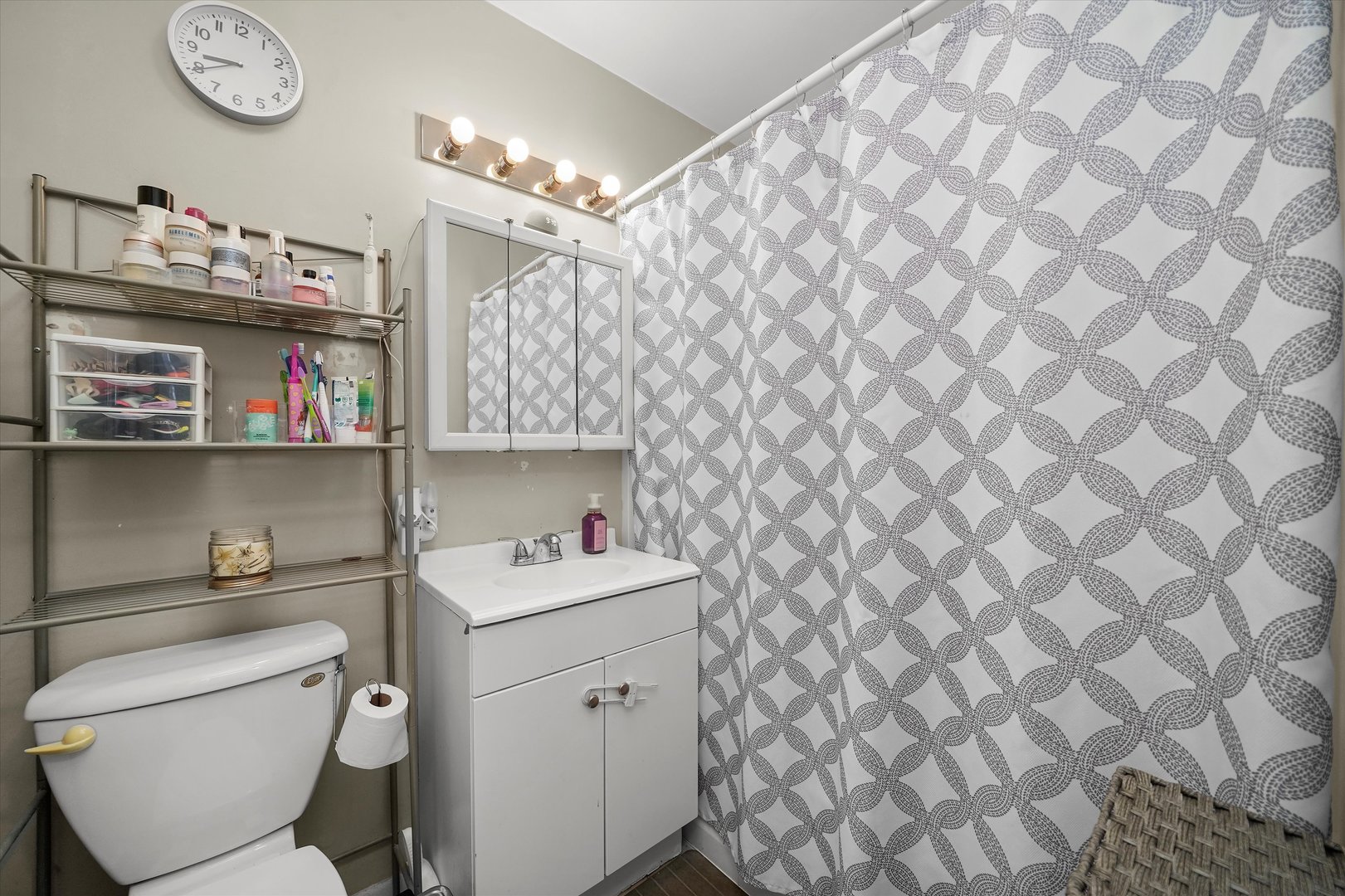 406 Cahill Road Streamwood, IL 60107 - Photo 14 of 22 a bathroom with a toilet a sink and a shower curtain