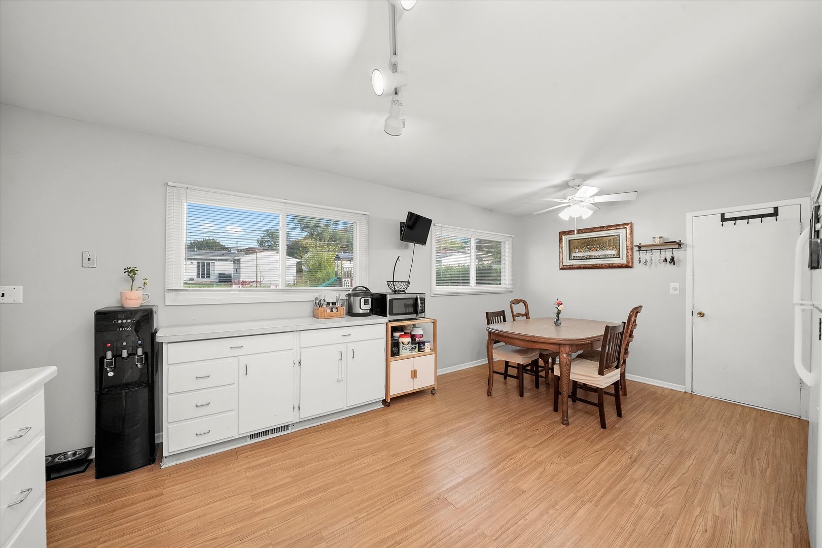 406 Cahill Road Streamwood, IL 60107 - Photo 7 of 22 a kitchen with a dining table chairs and wooden floor
