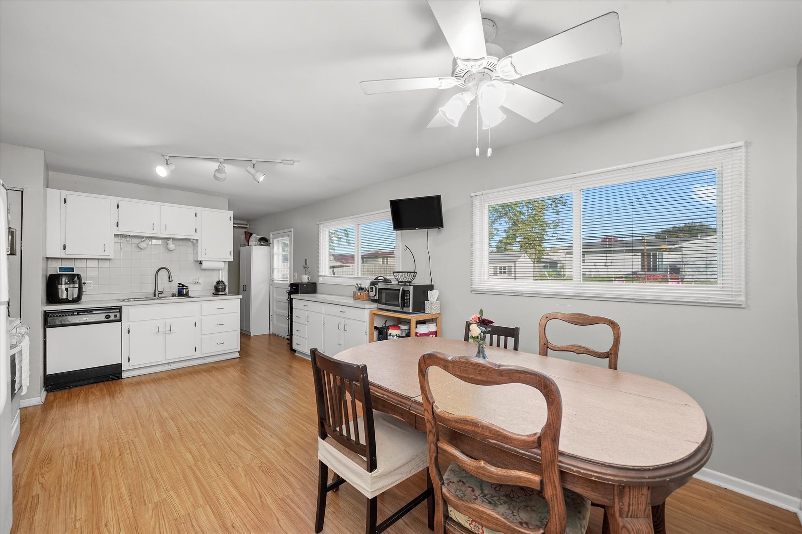 406 Cahill Road Streamwood, IL 60107 - Photo 10 of 22 a kitchen with stainless steel appliances a dining table and chairs