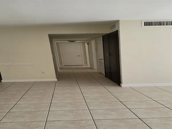 a view of an empty room and a window