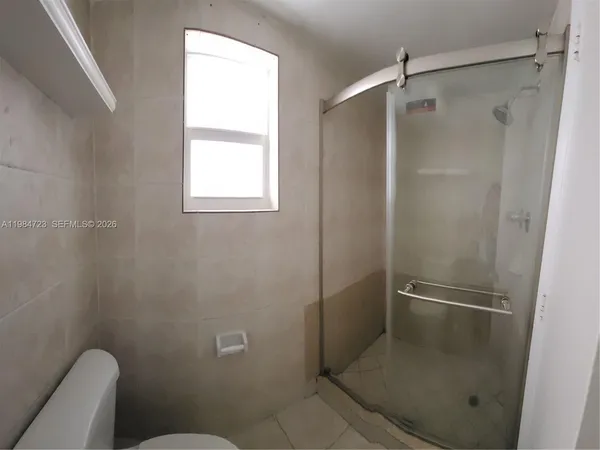 a bathroom with a granite countertop toilet