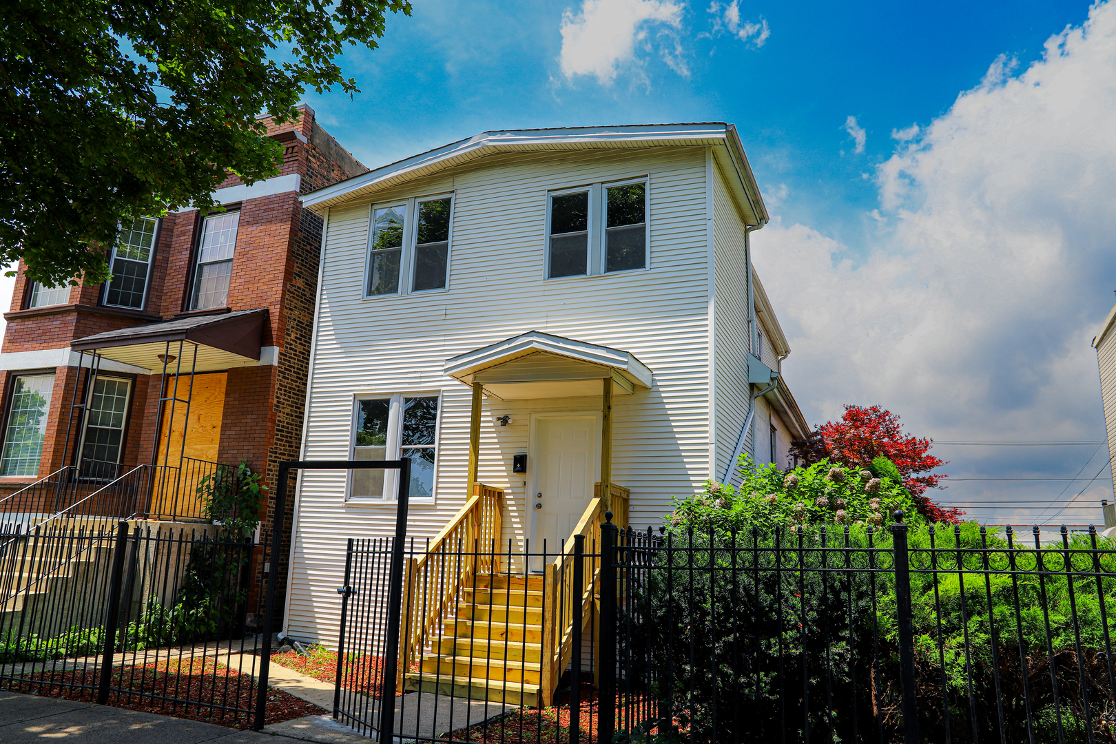 7046 South Wabash Avenue Chicago, IL 60637 - Photo 1 of 41 a front view of a house with a yard