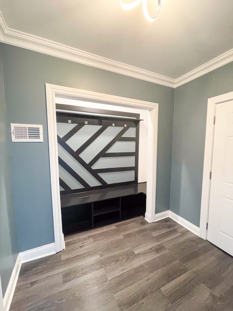 7046 South Wabash Avenue Chicago, IL 60637 - Photo 14 of 41 a view of an empty room with wooden floor and a window