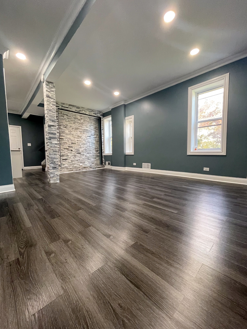 7046 South Wabash Avenue Chicago, IL 60637 - Photo 2 of 41 an empty room with wooden floor and windows