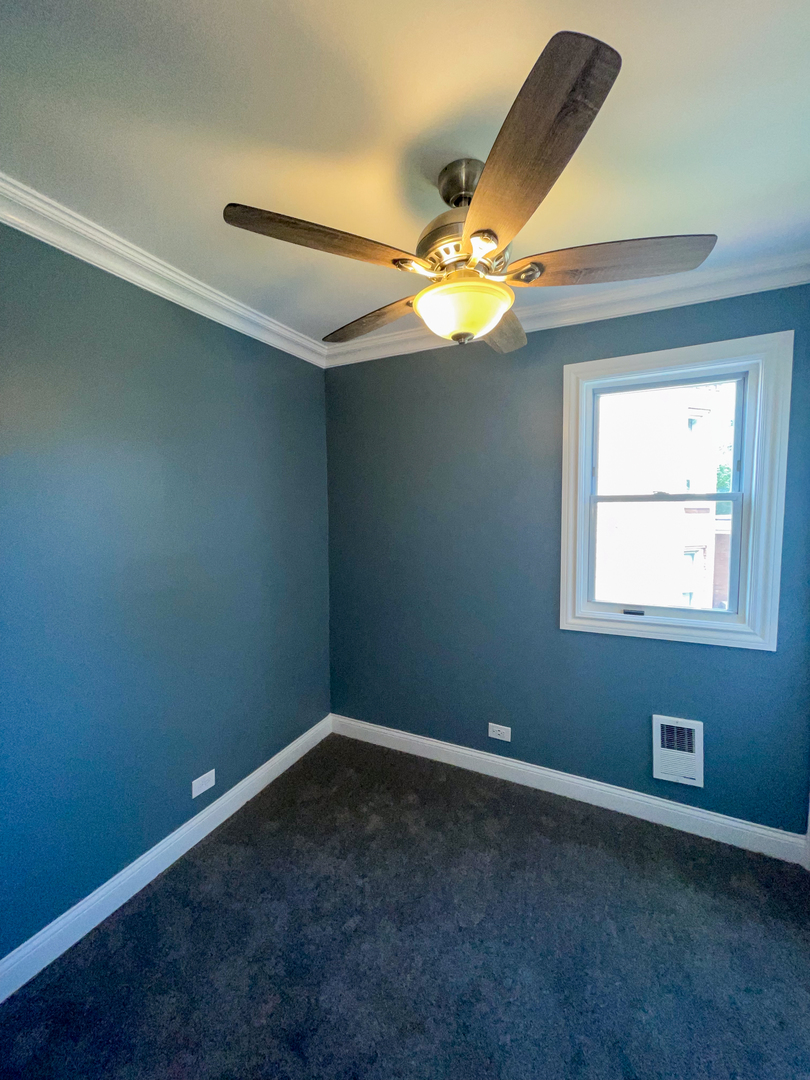 7046 South Wabash Avenue Chicago, IL 60637 - Photo 24 of 41 an empty room with windows and fan