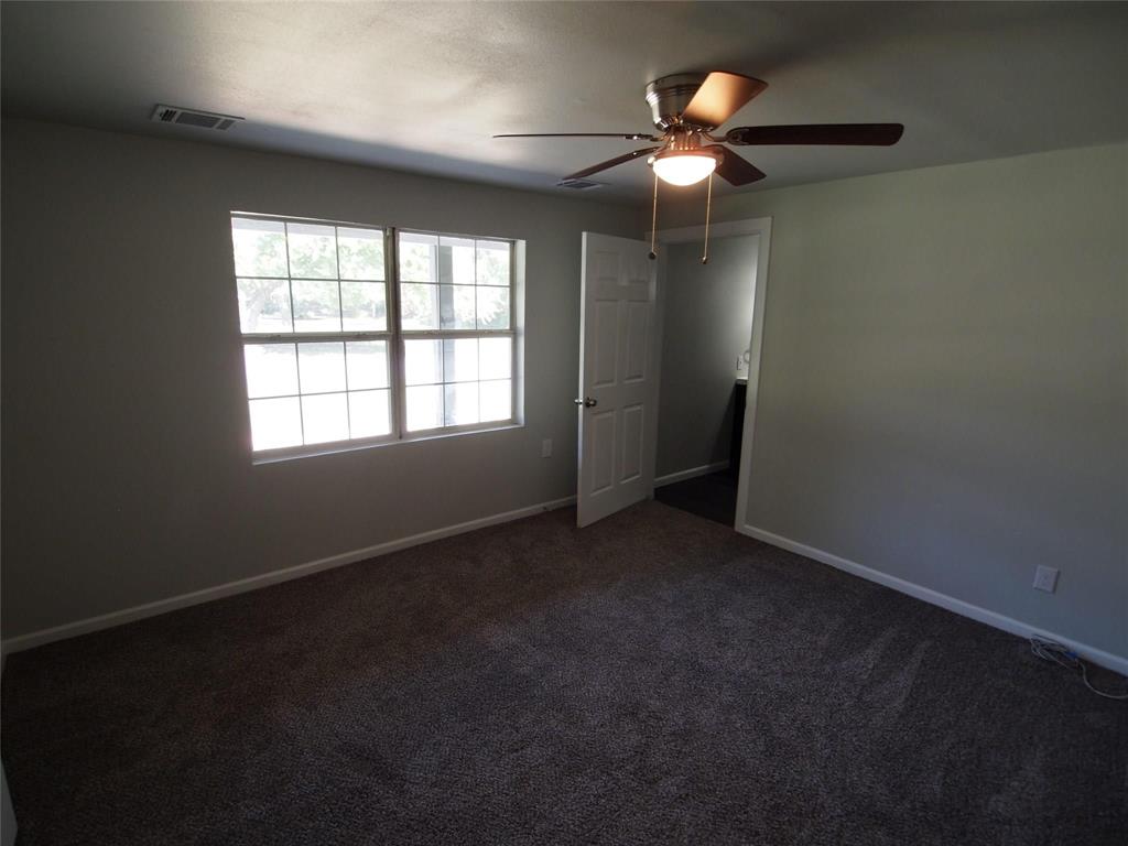 502 South Rusk Street Sherman, TX 75090 - Photo 13 of 15 an empty room with ceiling fan and window