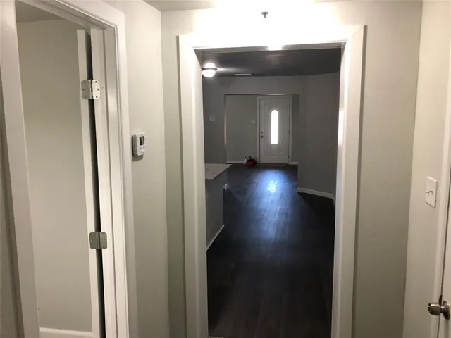 a view of a hallway with wooden floor