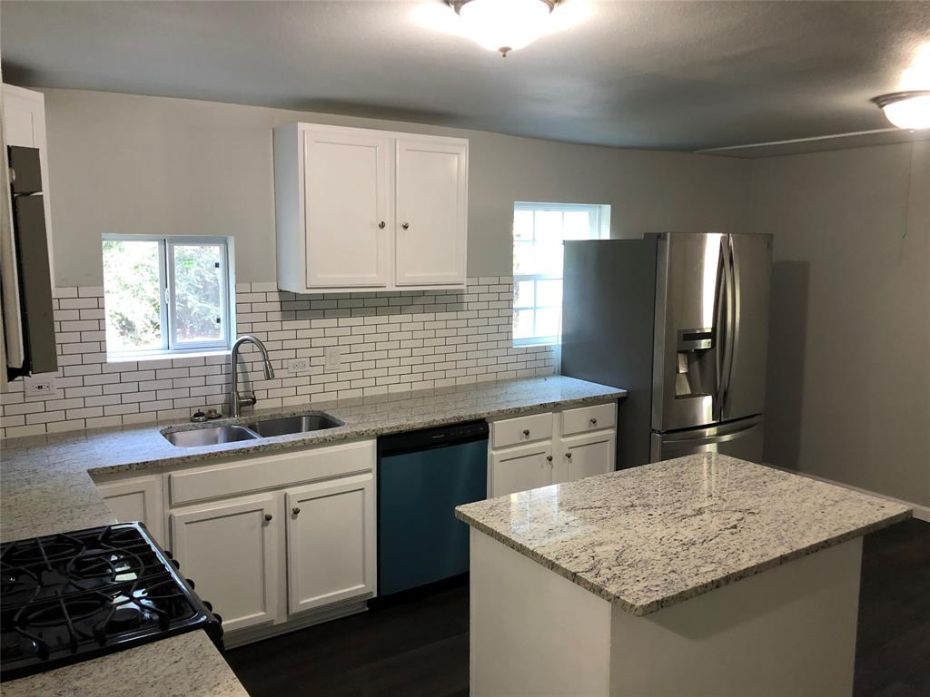 502 South Rusk Street Sherman, TX 75090 - Photo 5 of 15 a kitchen with a sink stove and cabinets