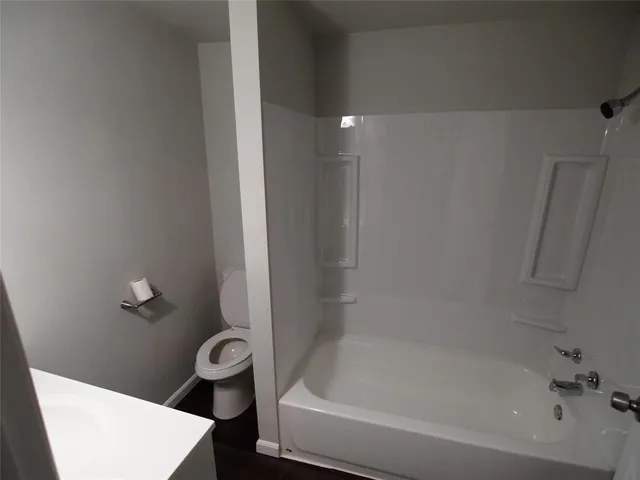 a bath tub sitting next to a toilet