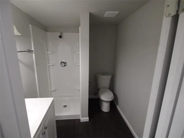 a bathroom with a toilet and a shower