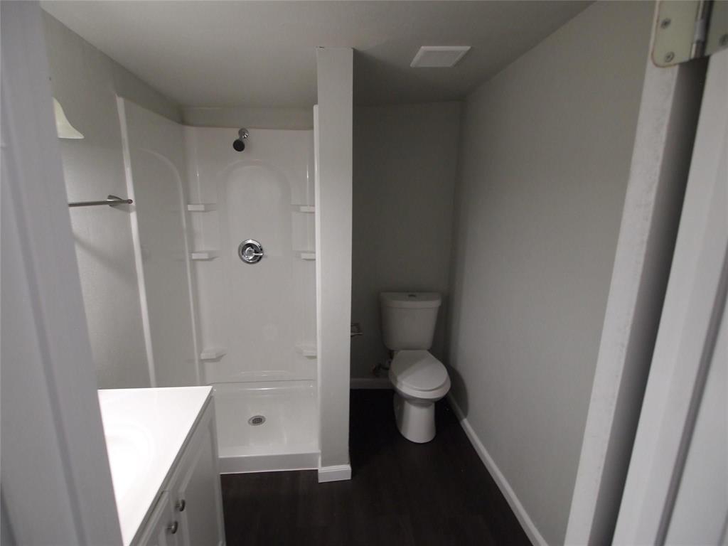 502 South Rusk Street Sherman, TX 75090 - Photo 9 of 15 a bathroom with a toilet and a shower