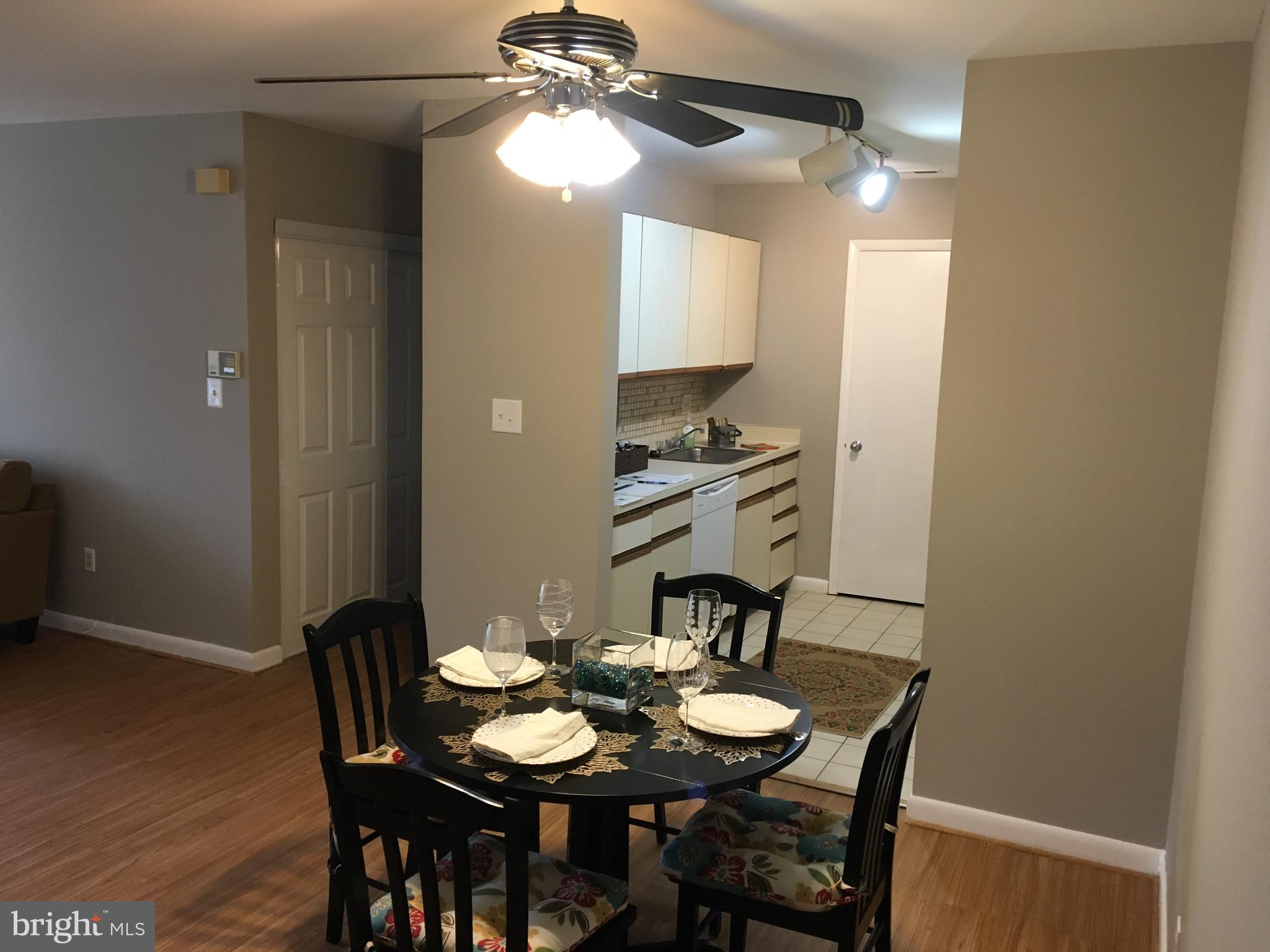 5570 Vantage Point Road, Unit 3 Columbia, MD 21044 - Photo 3 of 14 a view of a dining room with furniture and wooden floor