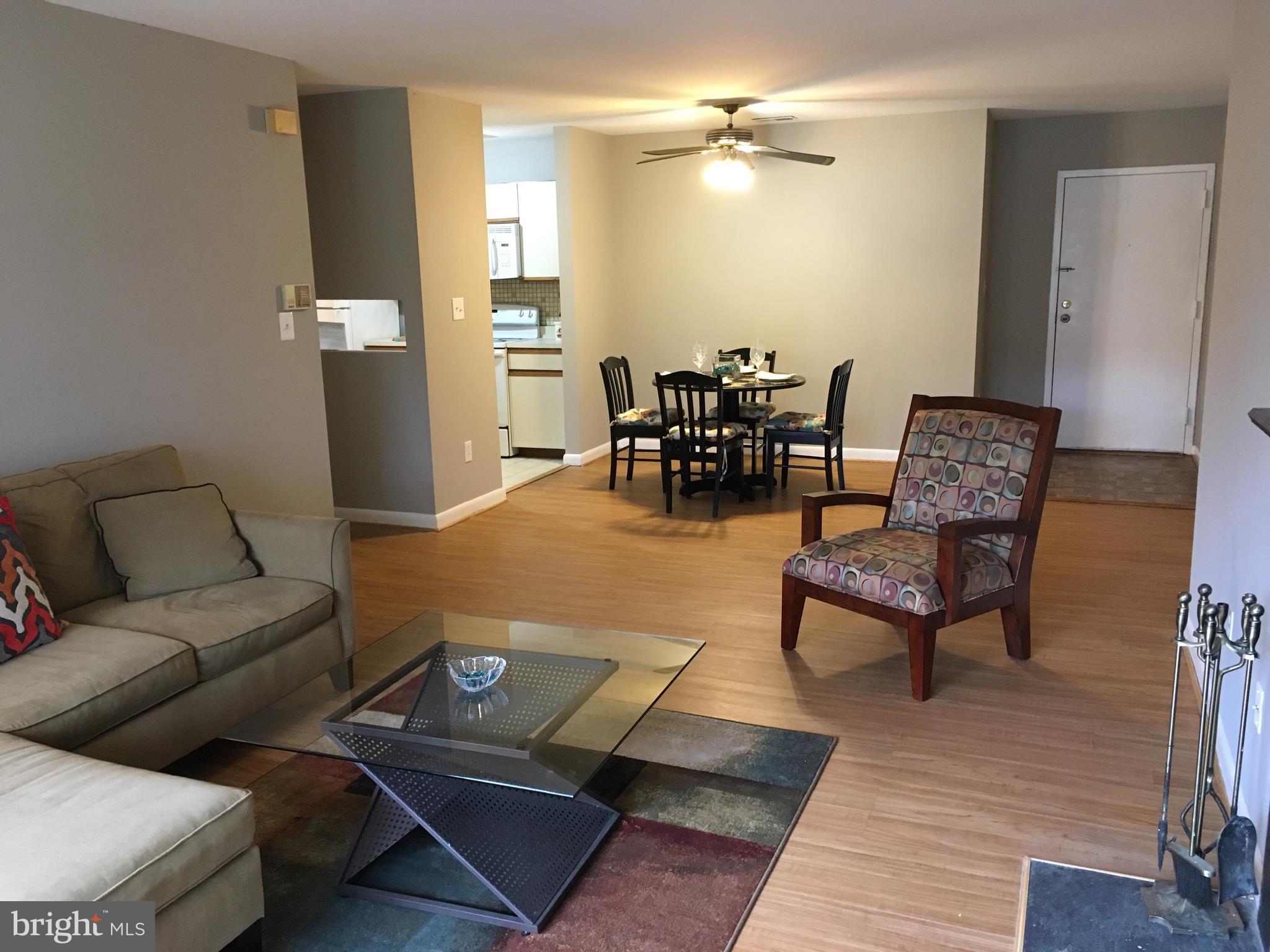 5570 Vantage Point Road, Unit 3 Columbia, MD 21044 - Photo 4 of 14 a living room with furniture and wooden floor