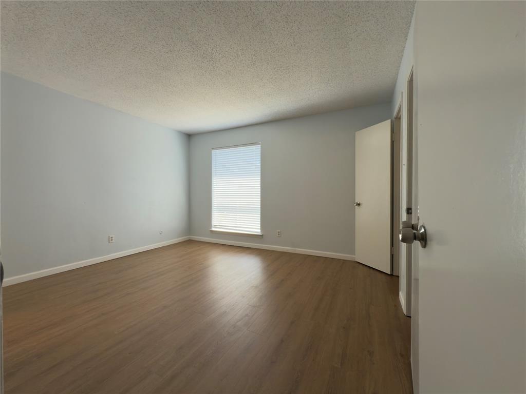 145 Trellis Place Richardson, TX 75081 - Photo 12 of 14 an empty room with wooden floor and windows