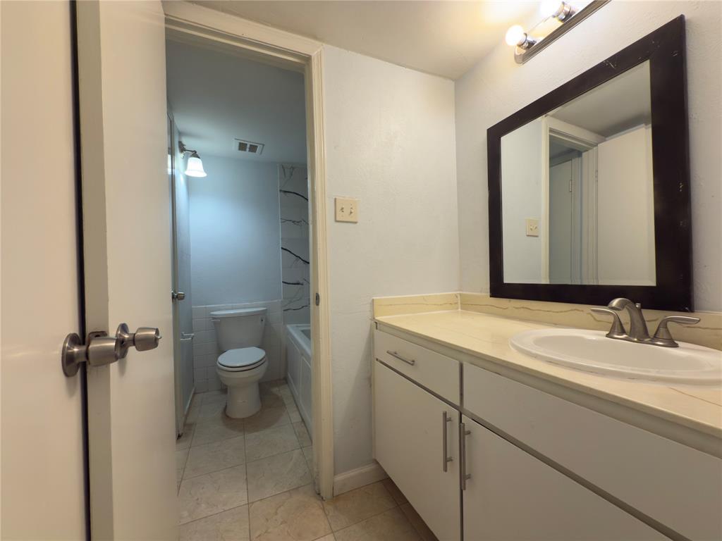 145 Trellis Place Richardson, TX 75081 - Photo 6 of 14 a bathroom with a granite countertop sink toilet and shower