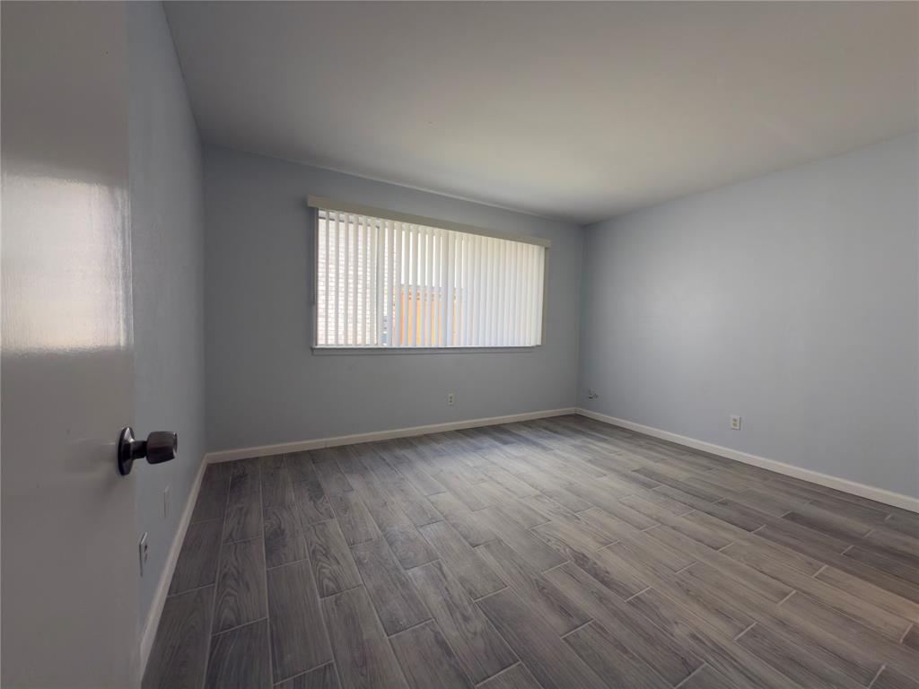 145 Trellis Place Richardson, TX 75081 - Photo 7 of 14 an empty room with wooden floor and windows