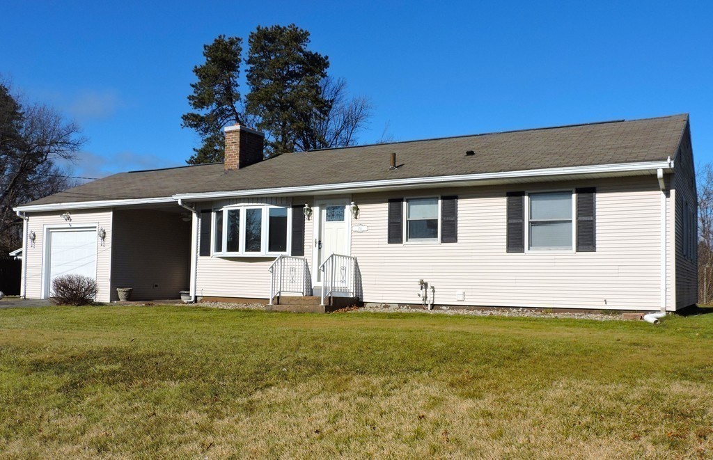 138 Ridgeview Circle Ludlow, MA 01056 - Photo 2 of 2 a view of a white house with a big yard and large trees