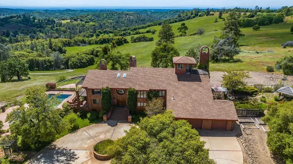 an aerial view of a house with a yard lake view and mountain view