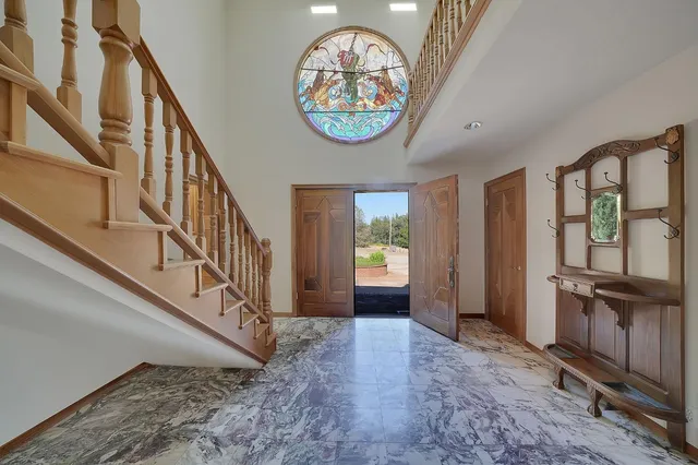 a view of living room with a floor to ceiling window and wooden floor