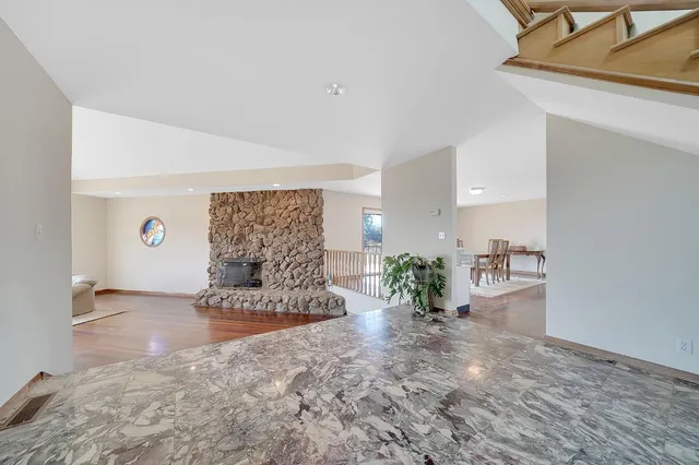 a living room with a large window and a floor to ceiling window