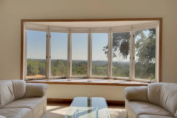 a dining room with furniture and window