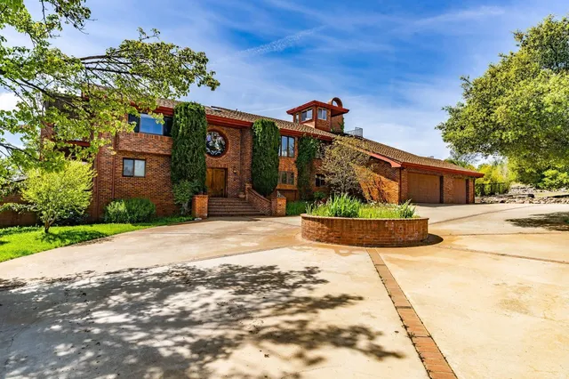 a front view of a house with a yard and a garage