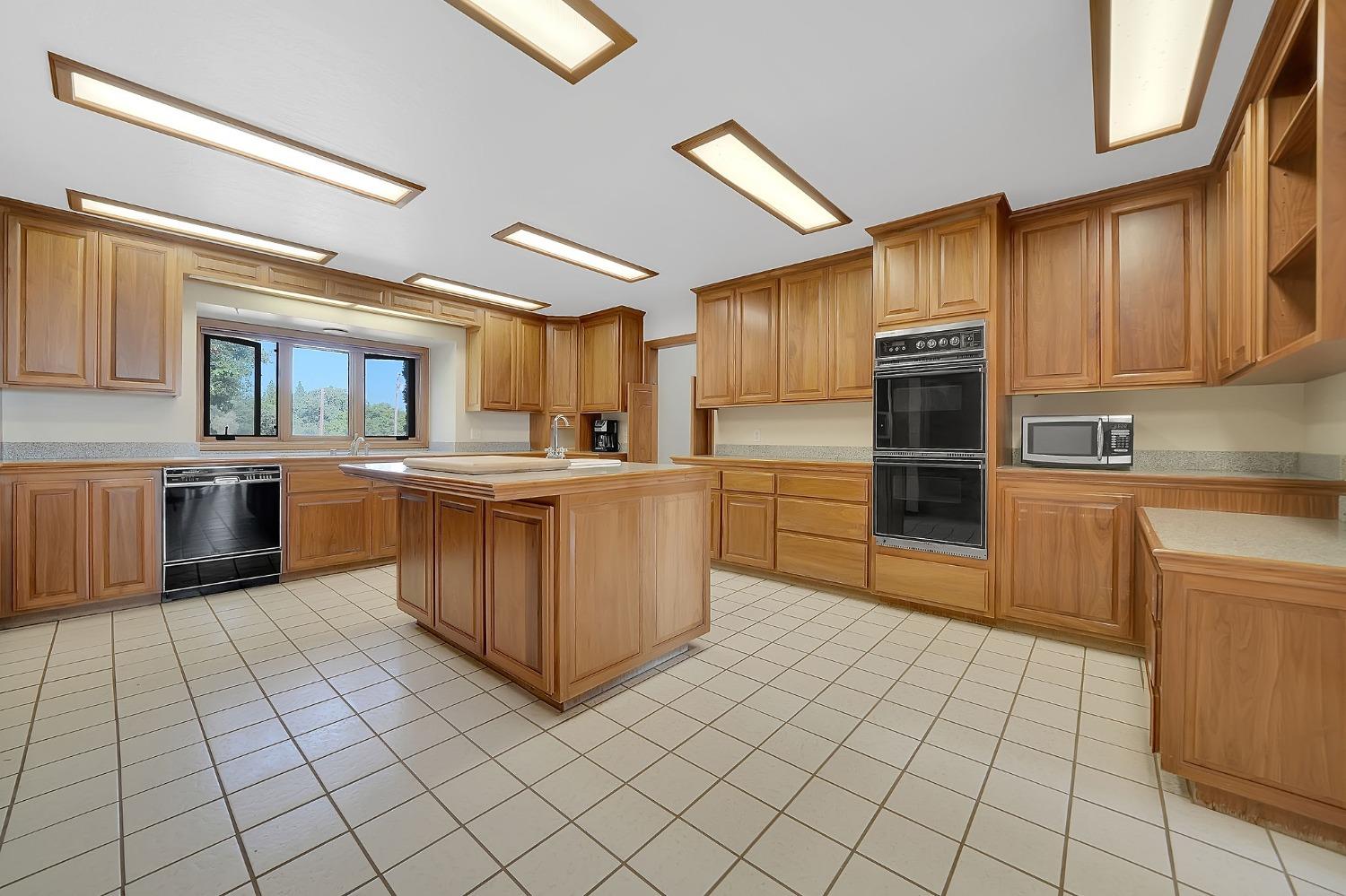 15111 Tyler Road Fiddletown, CA 95629 - Photo 26 of 92 a kitchen with stainless steel appliances granite countertop a stove top oven a sink and a refrigerator