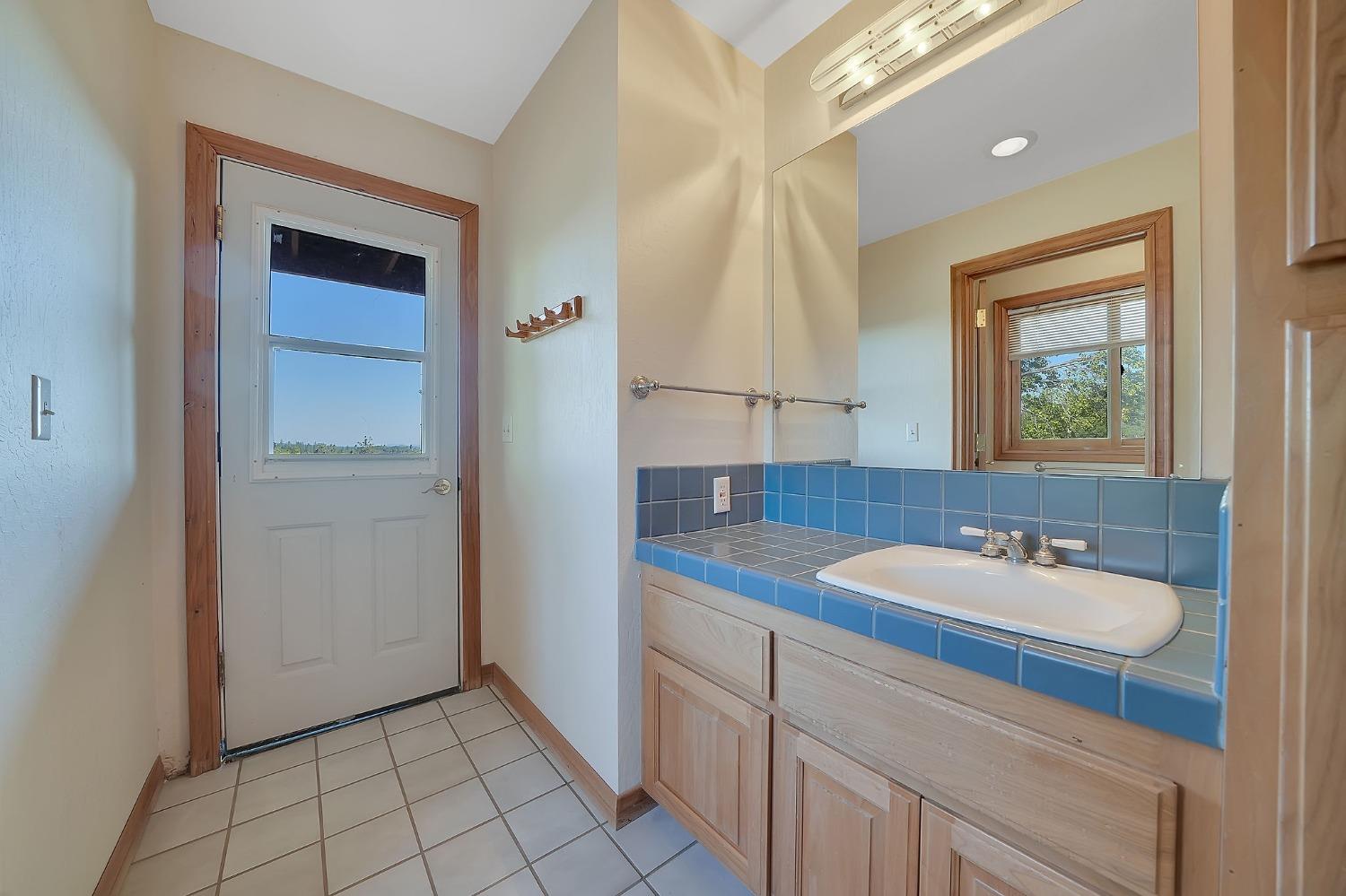 15111 Tyler Road Fiddletown, CA 95629 - Photo 33 of 92 a bathroom with a sink a vanity and a mirror