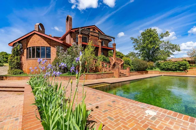 a view of a pathway of a house with potted plants