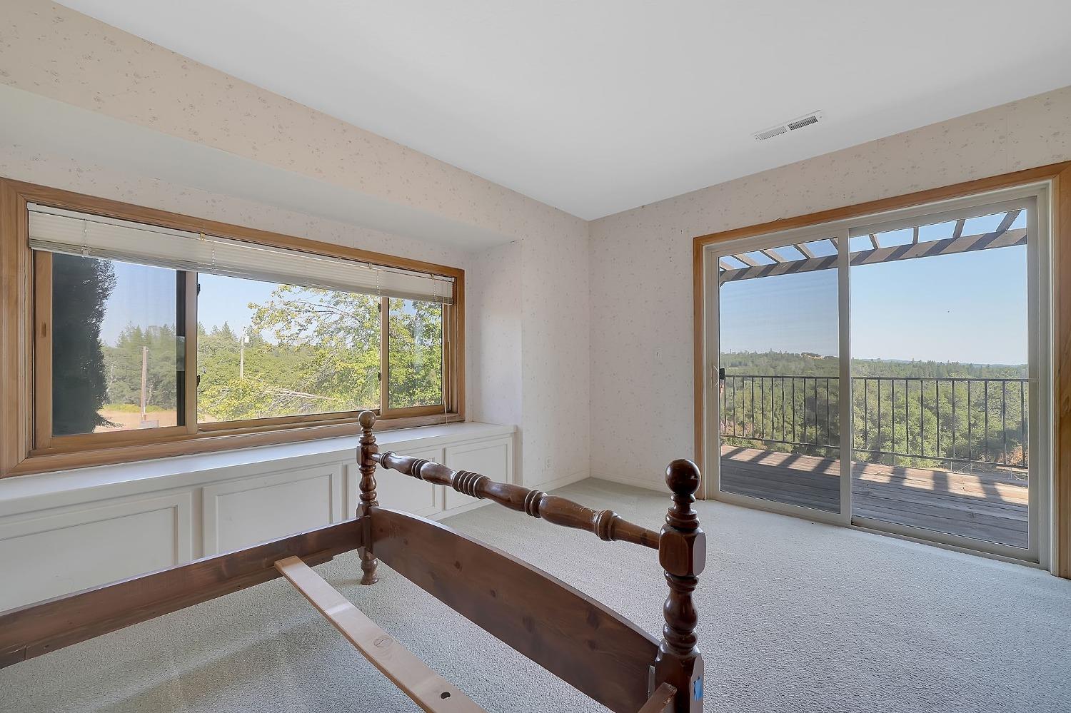 15111 Tyler Road Fiddletown, CA 95629 - Photo 49 of 92 a living room with a large window and a floor to ceiling window