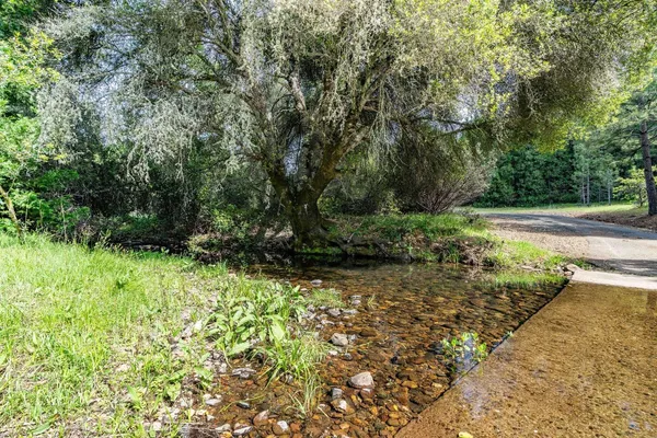a view of a livingroom with kitchen and couch
