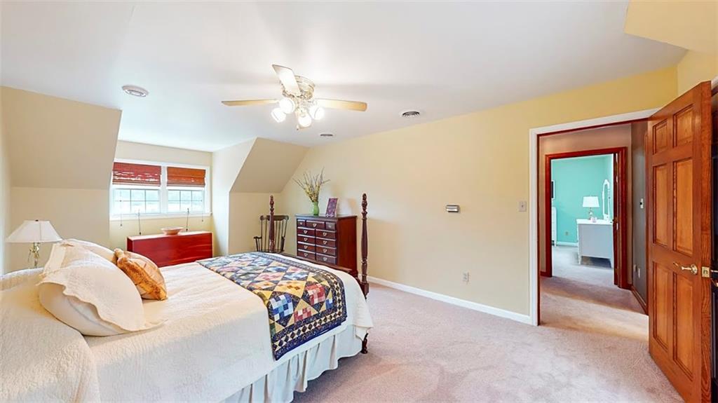 2163 Garards Fort Road Waynesburg, PA 15370 - Photo 19 of 25 a bedroom with a large bed and a chandelier