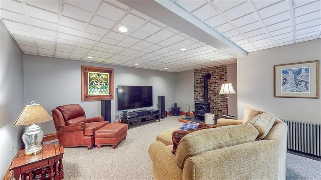 2163 Garards Fort Road Waynesburg, PA 15370 - Photo 22 of 25 a living room with furniture a flat screen tv and a fireplace