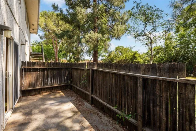 a view of a balcony with wooden fence and floor