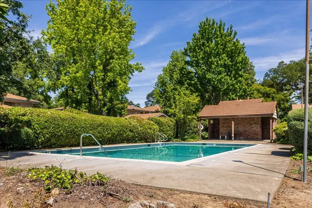 a view of house with outdoor space and trees