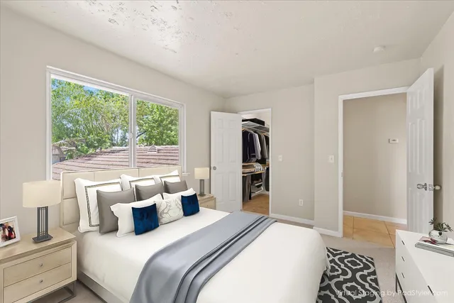 a bedroom with a bed and a window