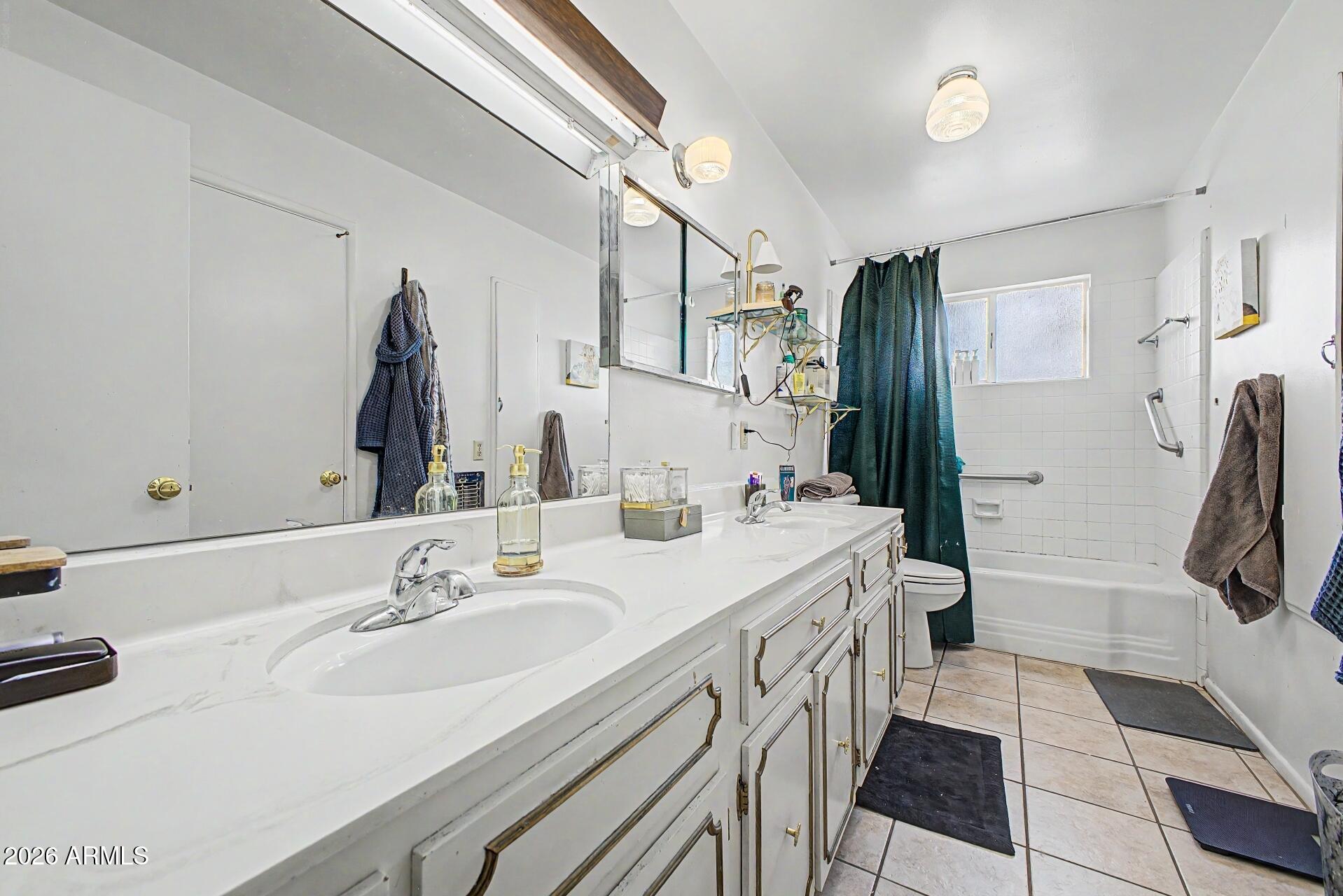 1702 East Griswold Road Phoenix, AZ 85020 - Photo 17 of 38 a bathroom with a double vanity sink a mirror and a shower