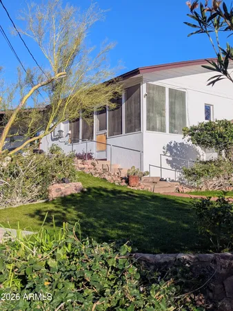 a front view of a house with a garden