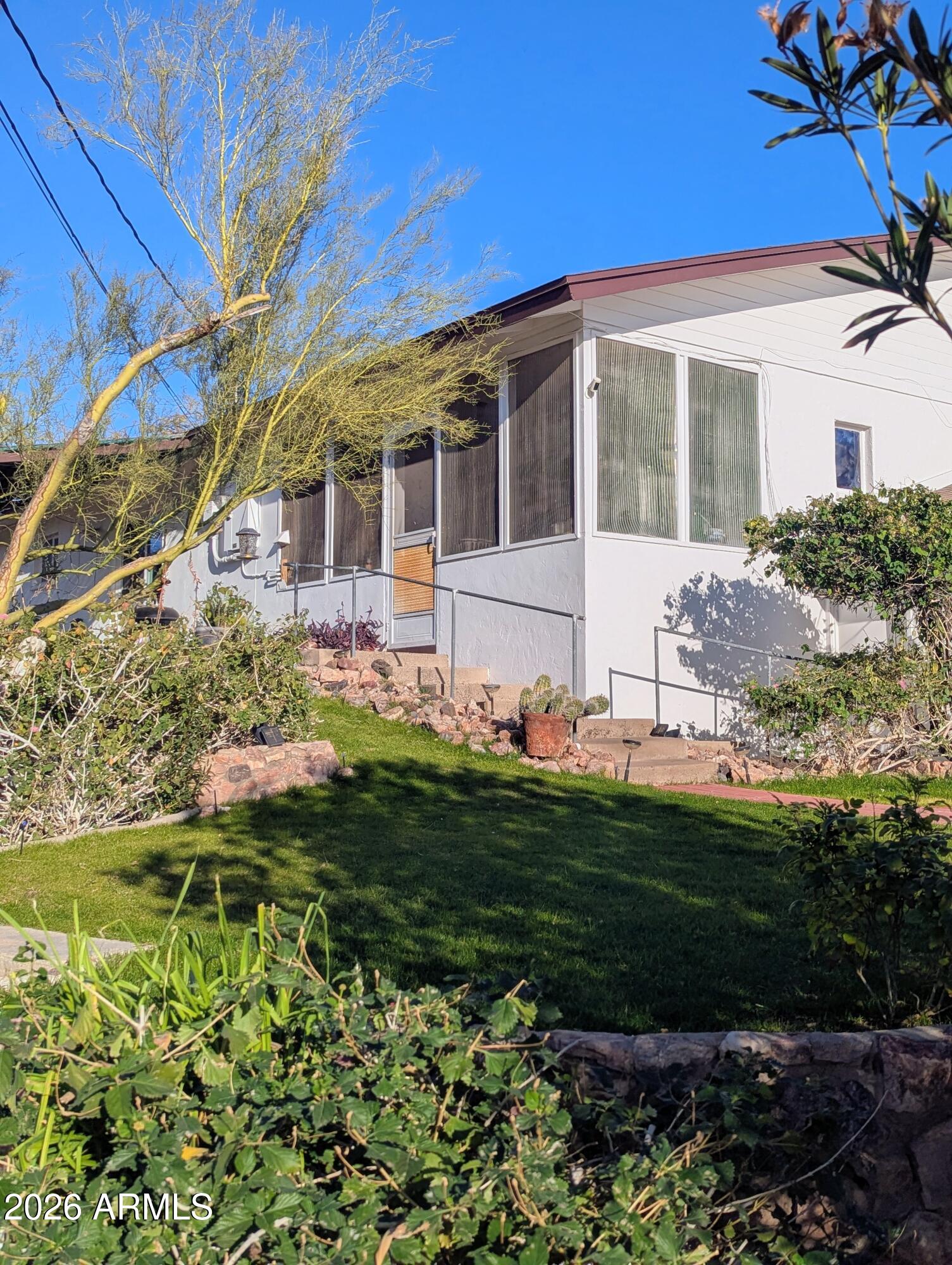 1702 East Griswold Road Phoenix, AZ 85020 - Photo 2 of 6 a front view of a house with a garden